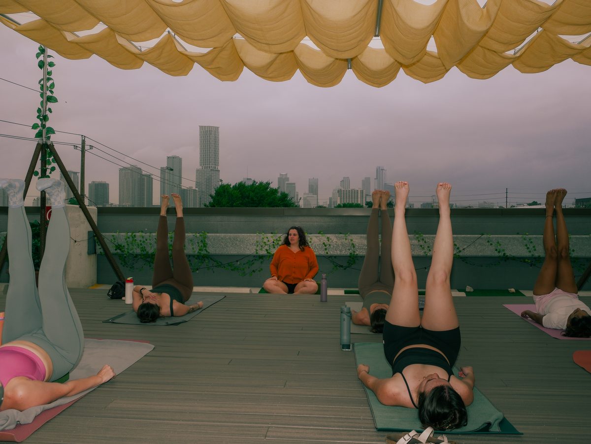 Rooftop yoga session in Austin with the city skyline behind