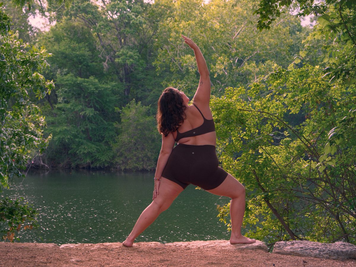 Seated meditation beside the green water of the Austin greenbelt